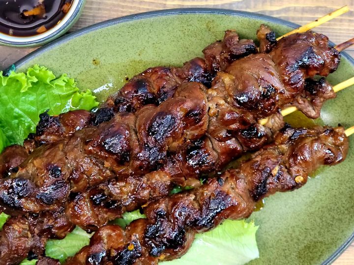 Grilled Filipino pork barbecue skewers arranged for a party spread